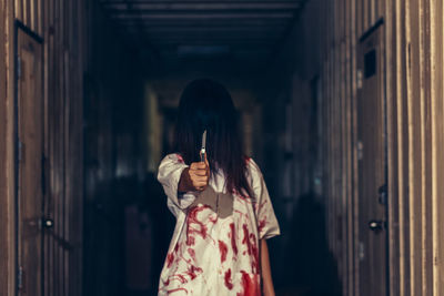 Woman standing against wall