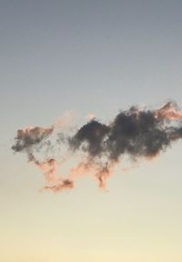 Low angle view of smoke stack against sky during sunset
