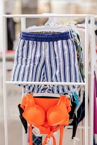 Close-up of clothes hanging in rack at store