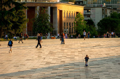 Group of people walking in front of building