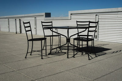 Deck chairs against clear sky