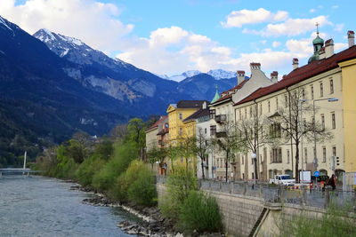 Beautiful building by the river, mountain and the blue sky in innsbruck, austria.