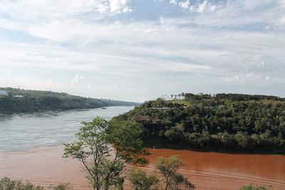 High angle view of trees and sea against sky