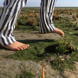 Low section of girl walking on ground