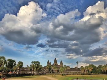 Panoramic view of buildings against cloudy sky