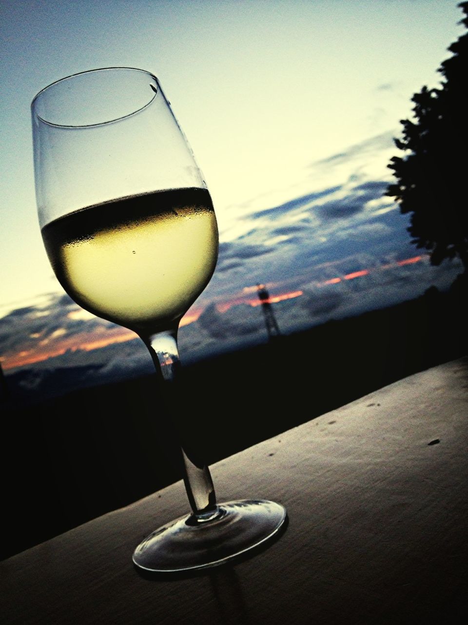 indoors, still life, table, drink, close-up, food and drink, lighting equipment, focus on foreground, glass - material, refreshment, no people, single object, transparent, drinking glass, low angle view, light bulb, alcohol, wineglass, illuminated, technology