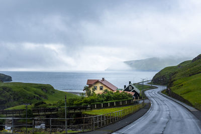 Road by sea against sky