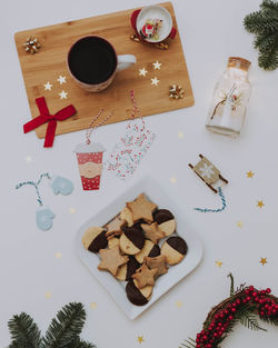 High angle view of coffee and cookies on table