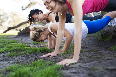 Happy athletes exercising on field