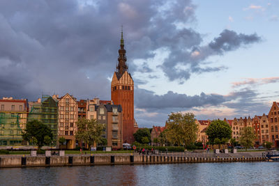 River amidst buildings against sky in city