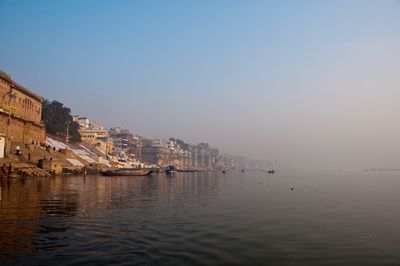 Scenic view of varanasi waterfront against clear sky