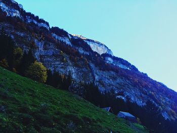 Low angle view of mountain against clear blue sky