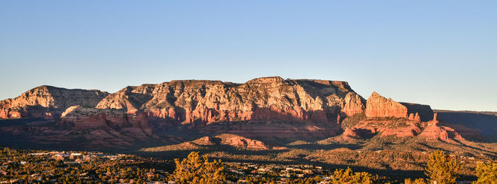 Rock formations on mountain against clear sky