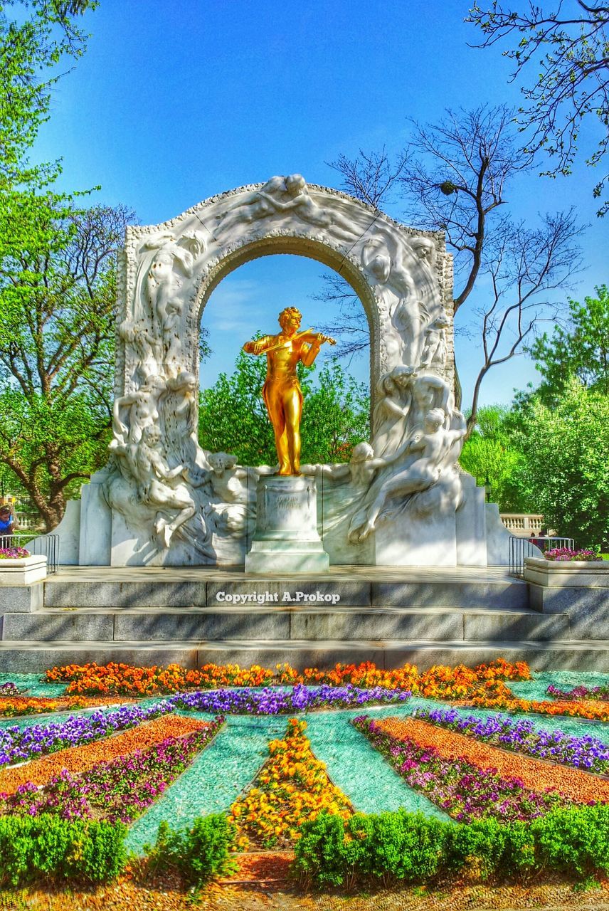 STATUE OF WOMAN IN GARDEN