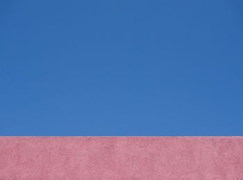 Low angle view of trees against clear blue sky