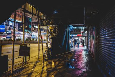 People in illuminated city at night