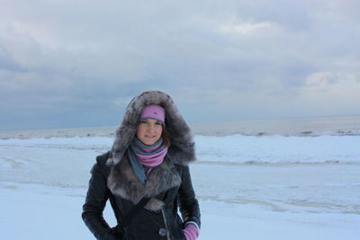 Portrait of young woman standing on snow