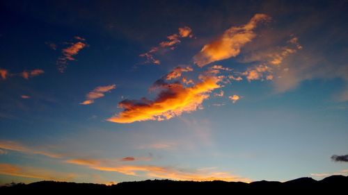 Low angle view of silhouette trees against sky at sunset