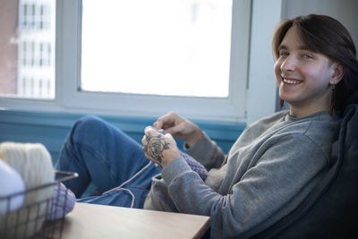 Portrait of young man using laptop at home