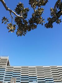 Low angle view of building against clear blue sky