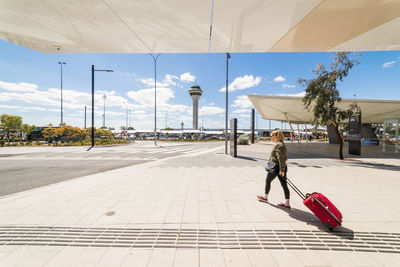 Man walking on footpath in city