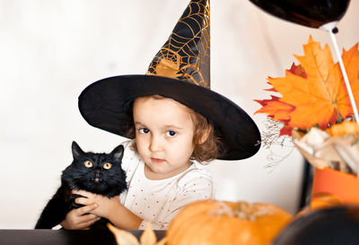 Portrait of cute girl with cat