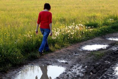 Rear view of woman walking on land