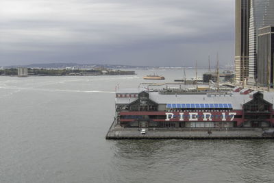 Scenic view of sea against buildings in city