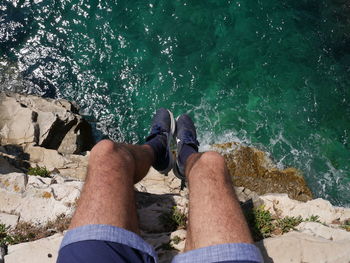 Low section of man legs on rock