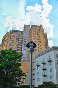 Low angle view of building against cloudy sky