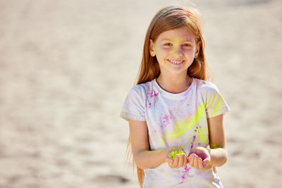 Portrait of young woman standing at beach