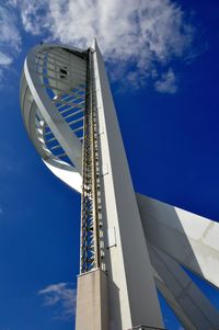 Low angle view of skyscraper against blue sky