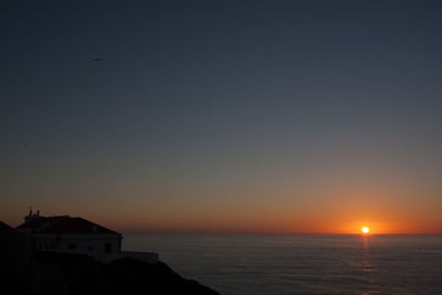 Scenic view of sea against clear sky during sunset