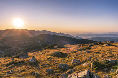 Scenic view of mountains against sky during sunset