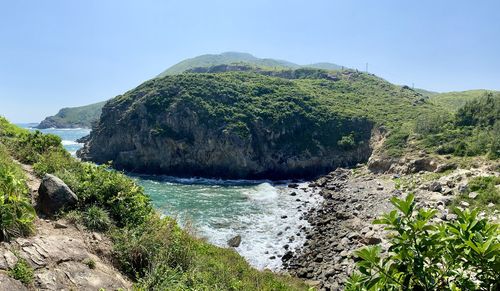 Scenic view of waterfall against sky