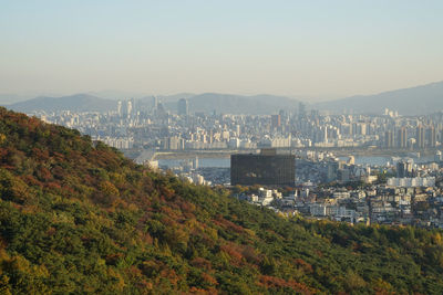 Scenic view of cityscape against sky during autumn