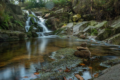 Scenic view of waterfall in lake