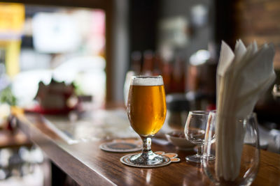 Close-up of wine glasses on table