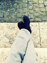 Close-up of woman standing on tiled floor