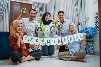 Family playing with toys on bed at home