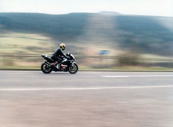 Man riding motorcycle on road