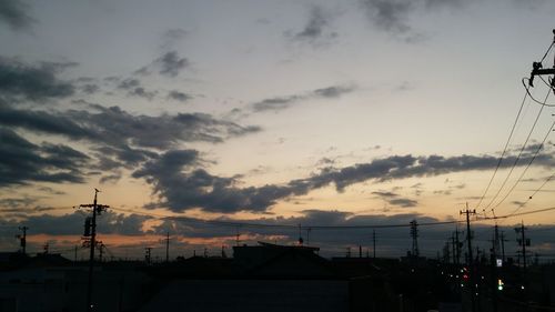 Silhouette city against sky during sunset