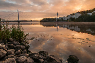 View of bridge over river against cloudy sky