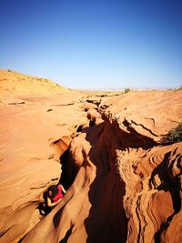 Scenic view of desert against clear blue sky