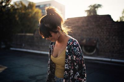 Young woman with umbrella on street