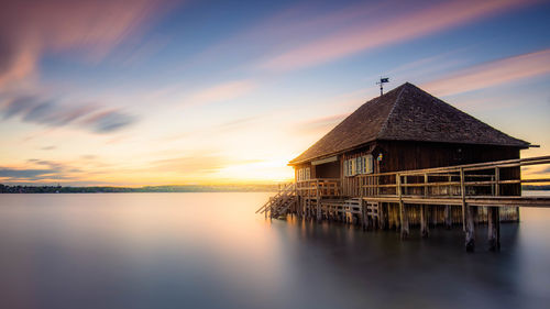 A beautiful sunset at a boathouse on the ammersee in bavaria