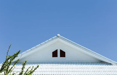 Low angle view of building against clear blue sky