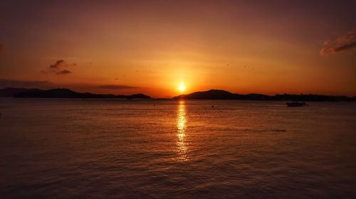 Scenic view of sea against romantic sky at sunset