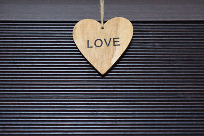 Heart shape with love text hanging on wall