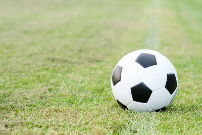 Close-up of soccer ball on grass